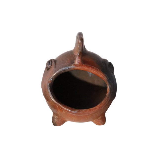 A brown ceramic fish ashtray in the style of Swedish artist Gunnar Nylund for Rörstand. A round body is defined with a...