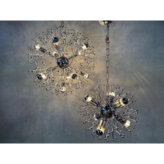 Striking space age hanging lamps in very nice condition. A: 6 x e14 light points. B: 11 x e14 light points. Both copies...