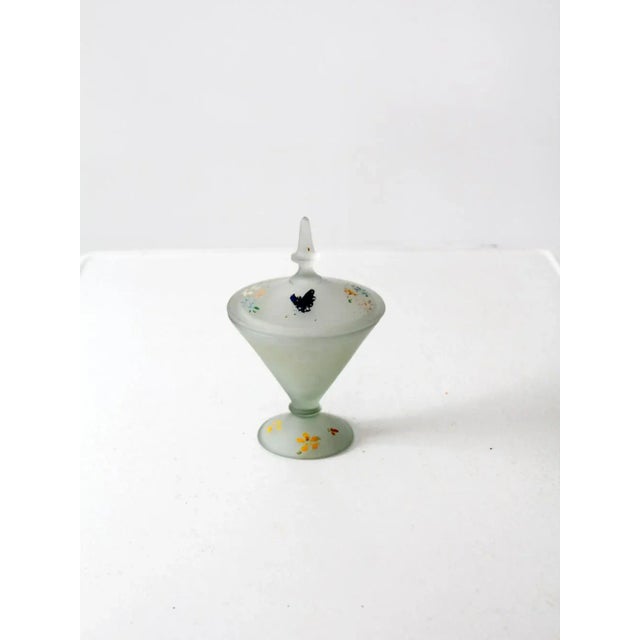 Hand-painted flowers blossom across this vintage satin glass candy dish from the early 20th century. The gray frosted...