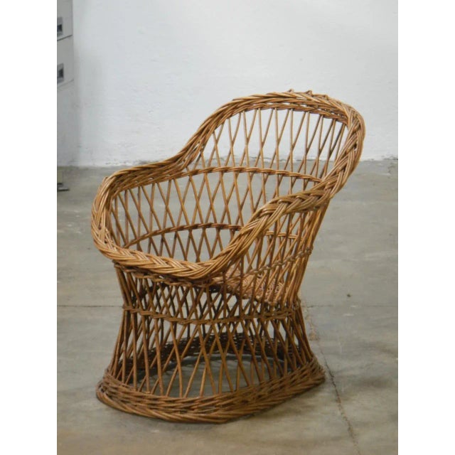 This wicker armchair was produced in Italy in the 60s.