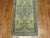 Long and narrow antique Oushak runner in blues, pinks on bone colored field. Close to 35 ft long.