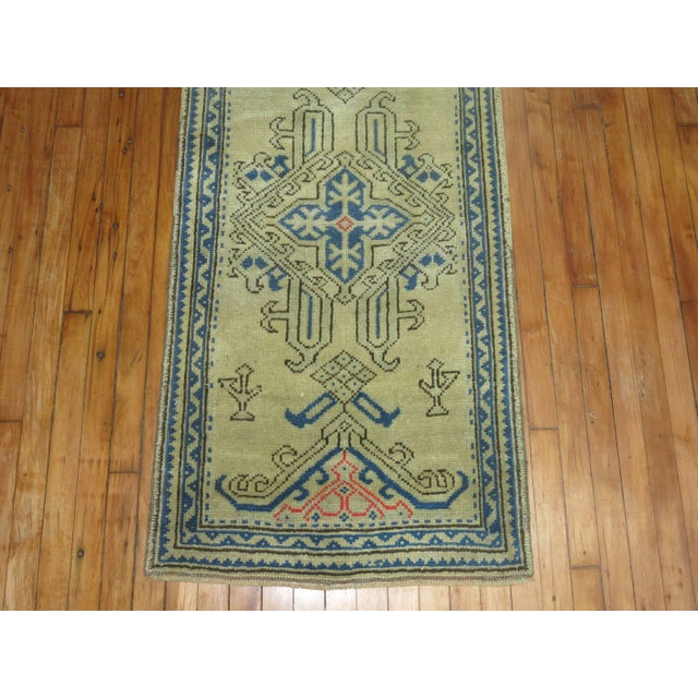 Long and narrow antique Oushak runner in blues, pinks on bone colored field. Close to 35 ft long.