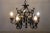 This special chandelier, made entirely of black iron, is a striking piece from the first half of the 20th century. Its...