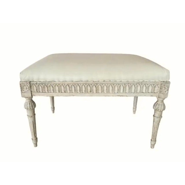 Antique Gustavian Style Hand-Carved Upholstered Stool. Stool features a neutral cream-colored top with painted and carved...