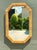 This elegant vintage octagonal wall mirror highlights the timeless appeal of mid-century design through its use of natural...