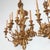 An impressive and exceptionally decorative pair of monumental mid-20th-century giltwood five-light wall sconces,...