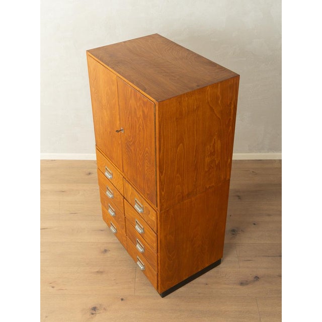 A wonderful chest of drawers from the 1950s. High-quality frame made of beech veneered particleboard with eight drawers...
