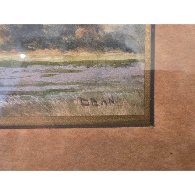 This framed landscape artwork presents a serene, atmospheric countryside scene in a narrow vertical format. The...