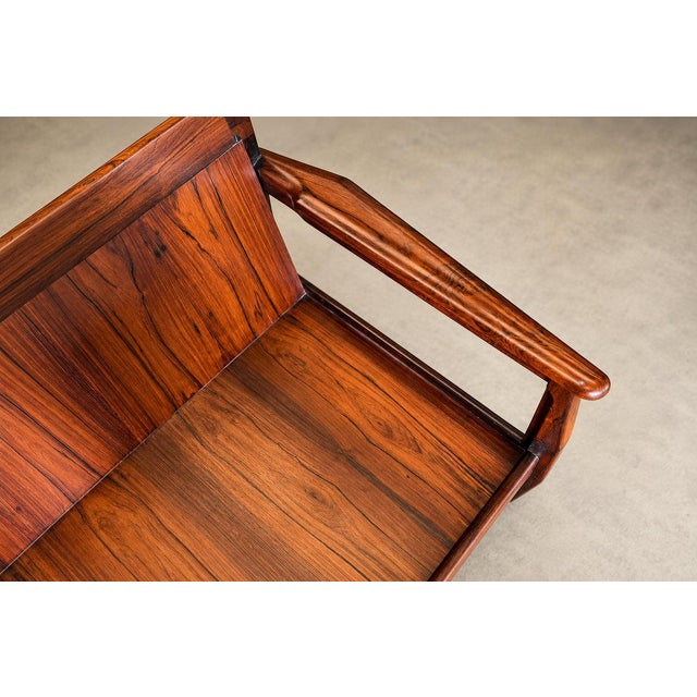 This generously proportioned Brazilian modern sofa pairs the warmth of richly figured rosewood with the soft, muted color...