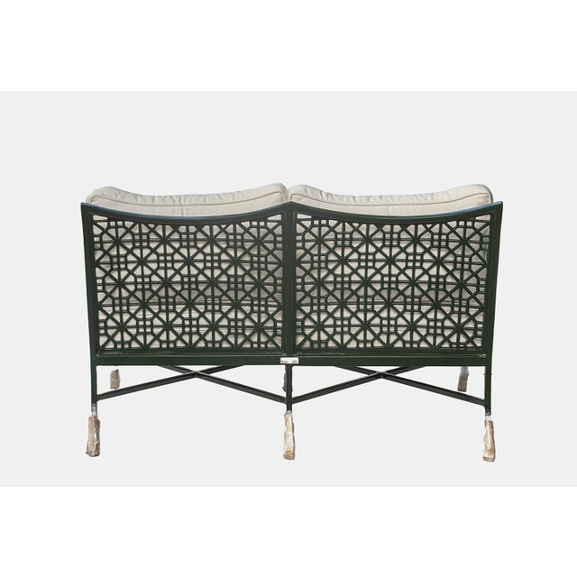 The Haret Outdoor Loveseat features distinctive signature fretwork detailing across the seat, and back accents, giving it...