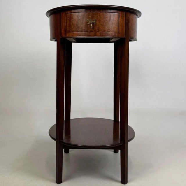 An elegant and well-crafted early 20th-century English Edwardian oval side table, beautifully constructed in mahogany and...