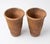 This pair of vintage Italian terracotta planters showcases a refined, tapered silhouette and a rich, weathered patina....