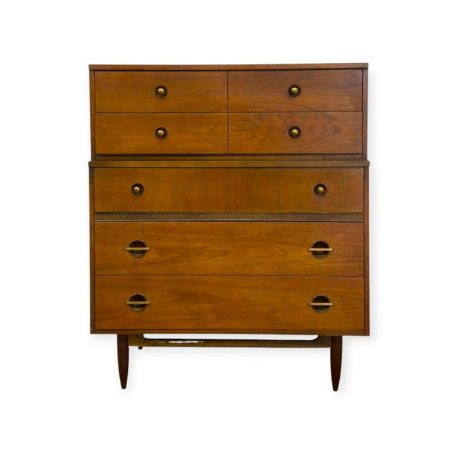 Crafted in genuine American walnut veneer, this vintage mid-century modern tallboy dresser combines versatile storage with...