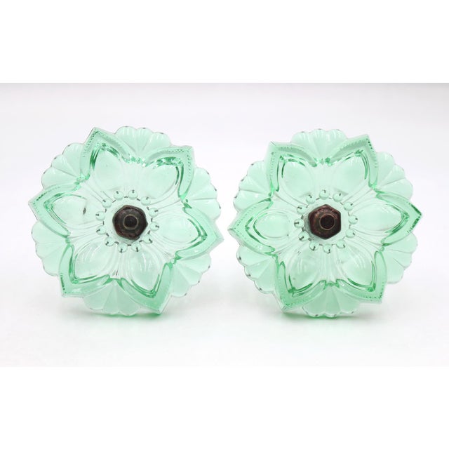 Vintage curtain tiebacks made of green pressed glass in a floral shape and brass hardware. Good condition with surface...
