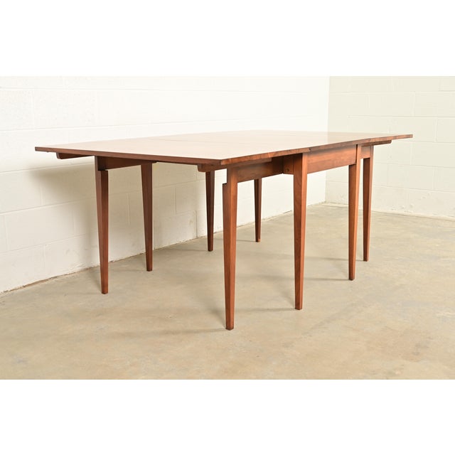 A gorgeous American Colonial style solid walnut drop leaf dining table or breakfast table By Henkel Harris USA, Circa...