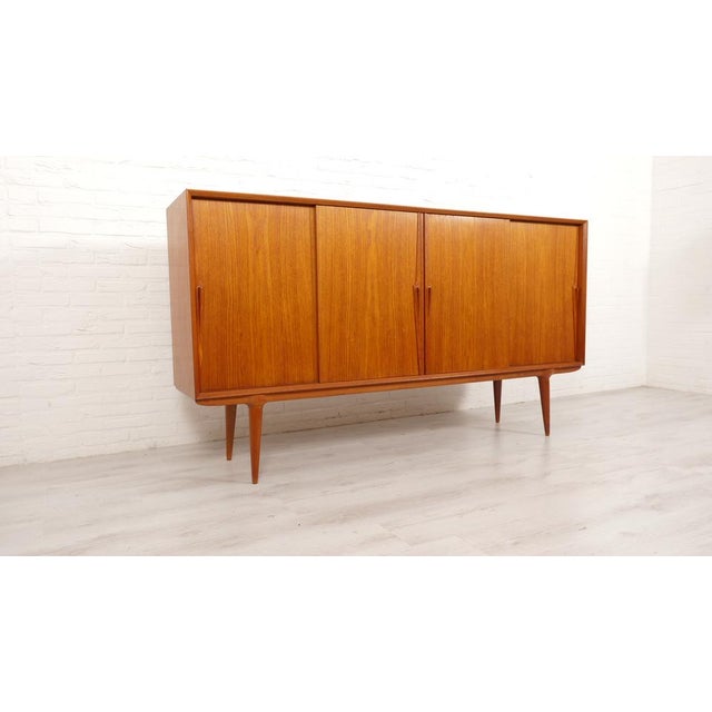 Bring Danish elegance into your home with this vintage highboard, designed by Omann Junn for Gunni Omann in the 1960s....