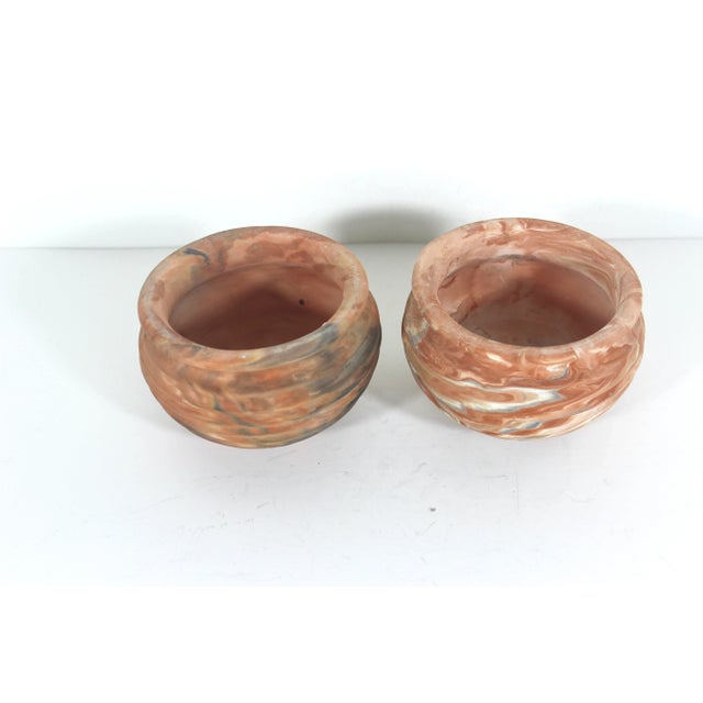 This is a pair of small vintage planters made by Comanche Pottery out of Texas. They are made of swirled unglazed...