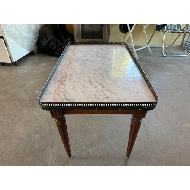 This wonderful and charming vintage mahogany coffee table base and topped with an outstanding piece of white marble...
