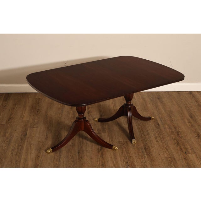 High Quality American Made Expandable Mahogany Dining Table On Double Pedestal Base with Brass Capped Feet, Includes Four...