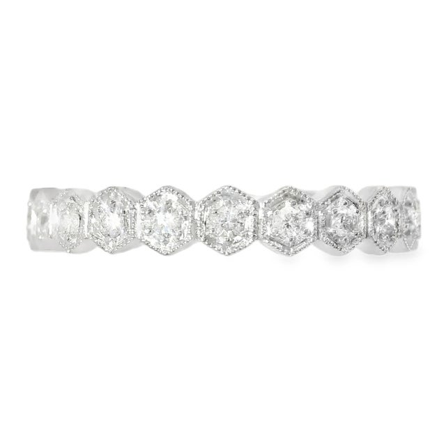 18K white gold eternity band with 22 round diamonds totaling 0.3 carats. Band width 1/8 inch. Ring size 6.5. Weight 2.5...