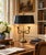 A classic bouillotte lamp rendered in warm brass, distinguished by its sculptural double horn base and clean, tailored...