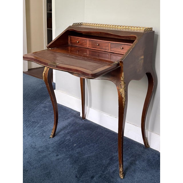 Antique French Louis XV Mahogany painted writing desk featuring a brass gallery top, a flip down writing table, lock and...
