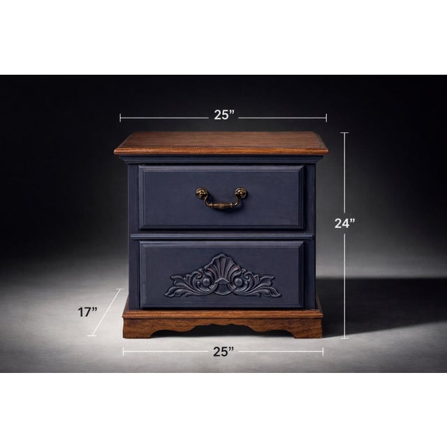 A charming pair of solid wood nightstands featuring a rich navy blue painted finish paired with warm walnut tops. The...