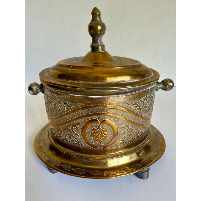 Here is a wonderful late 19th-early 20th century Moroccan brass tea caddy, beautifully hand-worked with a combination of...