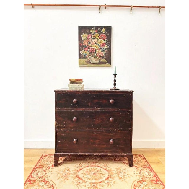 A lovely two over two arranged set of pine drawers, scumbled with original dark mahogany grain, with bracket legs....