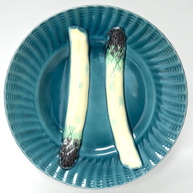 Six majolica plates having a most alluring teal blue glaze and embossed trompe-l'œil asparagus spears, a sauce well and...