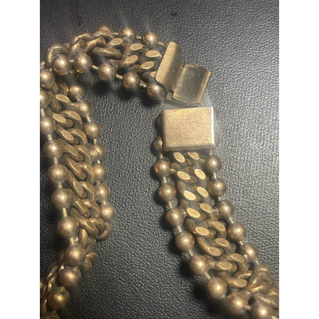 This Mid-Century Modern (MCM) statement necklace features an industrial, brutalist-inspired multi-strand design. Very...