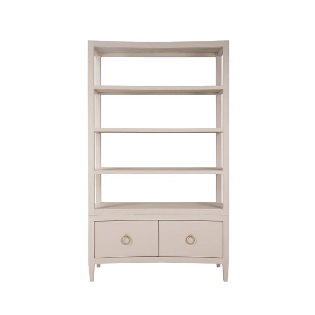Wrapped in soft pale blue linen, this tall shelving unit features a subtly concave front that introduces movement and...