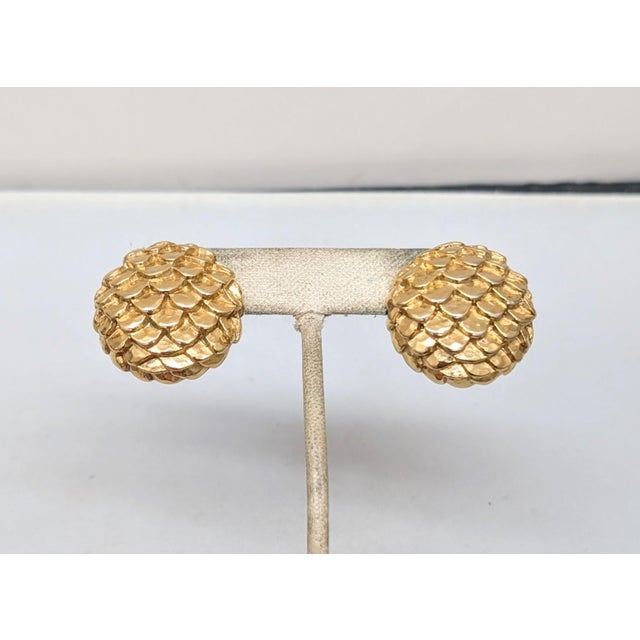 1980s round domed goldtone scales pierced push back earrings with silvertone posts. Marked within a circle on the back...