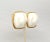 This is part of Chairish’s Costume Jewelry assortment. 1970s or early 1980s modernist goldtone white molded resin clip...