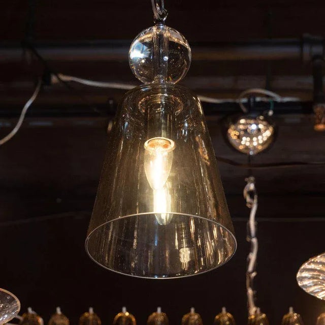 This sophisticated Mid-Century Modern pendant was realized in the United States, circa 1970. It features a translucent...