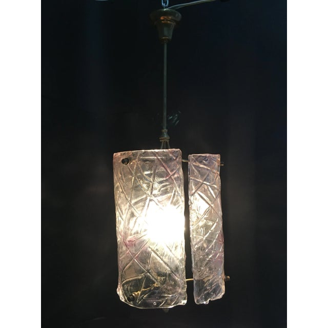 This ceiling light is made of three hand-blown glass plates on a brass structure. It supports LED bulbs. This piece is...