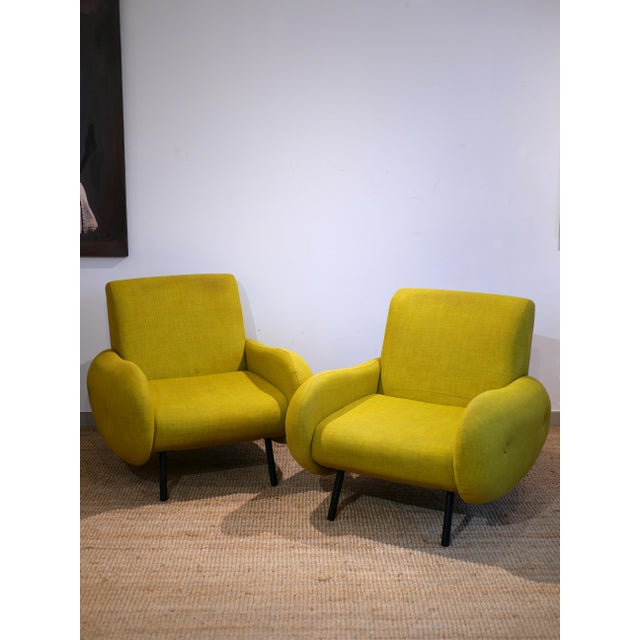 Pair of armchairs with enveloping and generous lines, inspired by 1960s-70s design. The proportions are soft and balanced,...
