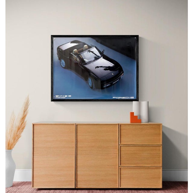 The Piece This original vintage poster presents the Porsche 944 S2 Cabriolet in a sleek, high-angle studio composition....