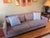 The Cameron Crate & Barrel sofa is a standout in any living room, upholstered in a soft, textured gray linen-blend fabric...