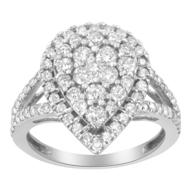 A bold silver and diamond cluster ring. This pear-shaped ring is made with 80 round-cut, natural diamonds in a prong...