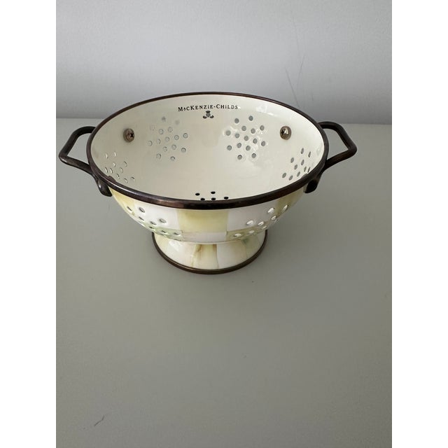 Perfect as a berry colander and serving bowl due to its size, this 2010s Mackenzie-Childs Parchment Check metal-enamel...