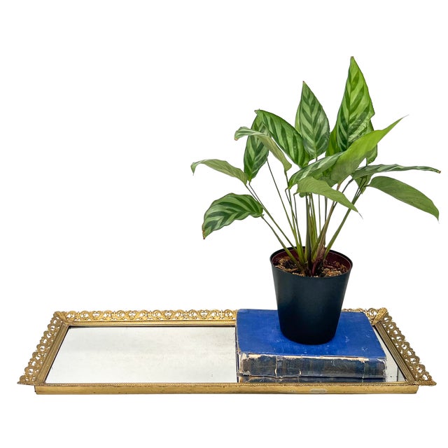 Elegant, mid-late 20th century rectangular mirrored tray framed in ornate gold-tone metal, featuring openwork floral...