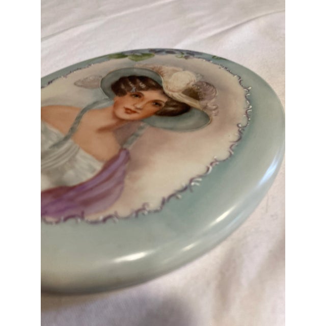 Elevate your space with this exquisite vintage hand-painted porcelain vanity mirror. Showcasing a charming lady in a...