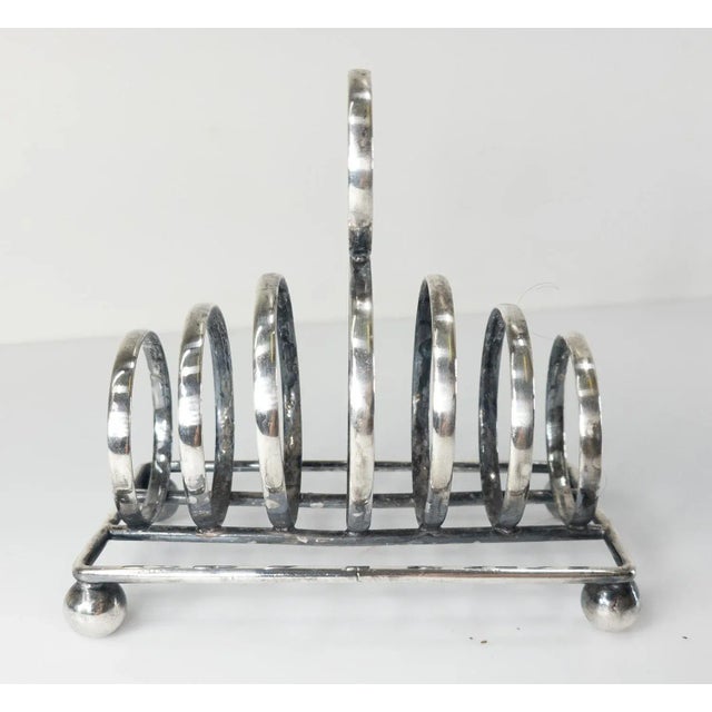 We are selling this stylish Victorian English Sheffield silver plate toast rack by James Deakin & Sons probably influenced...