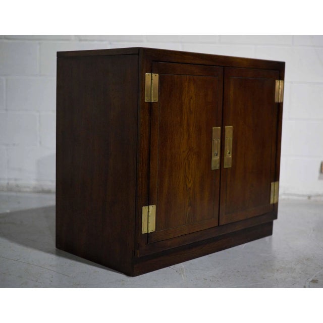 Add timeless character and versatile storage to your space with this 1970s Campaign 2-Door Chest by Dixie Furniture, Act...