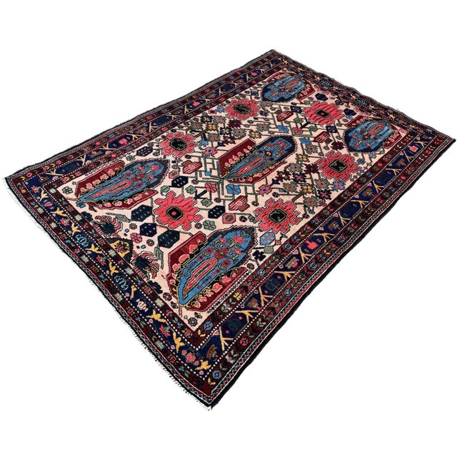 A wonderful antique Bakhtiar rug, woven circa 1910. The design features five large floral motifs interspersed with large...