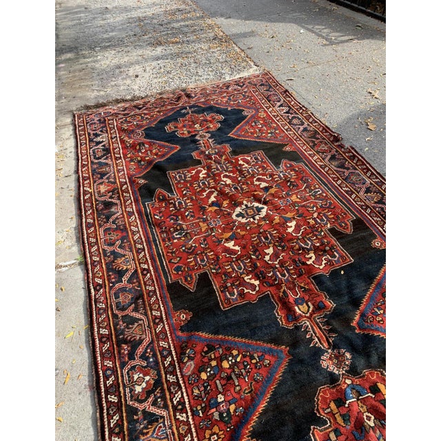 Immerse your space in the artistry and heritage of Persian craftsmanship with this handmade antique Persian Luri wool rug,...