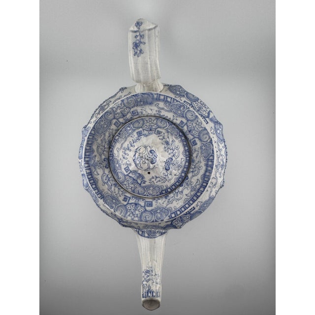 An authentic early 19th-century English blue and white transferware teapot, produced in Staffordshire during the height of...