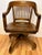 Bring a timeless presence to your workspace with this exceptional early 20th-century vintage banker's chair. A beautiful...