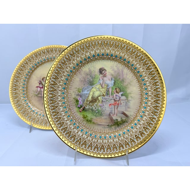 This exquisite pair of antique Royal Vienna porcelain plates, measuring 9.5 inches in diameter, beautifully illustrates...